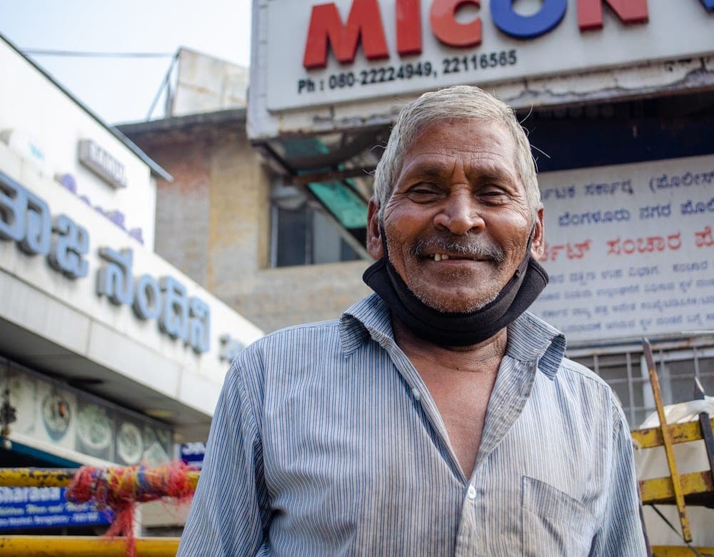 A shop owner standing outside his shop